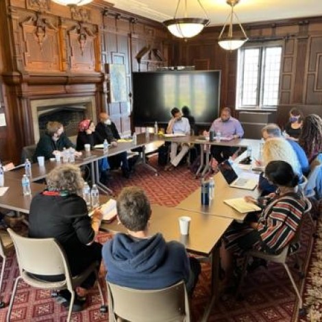 A group meeting around a conference table on the UChicago campus