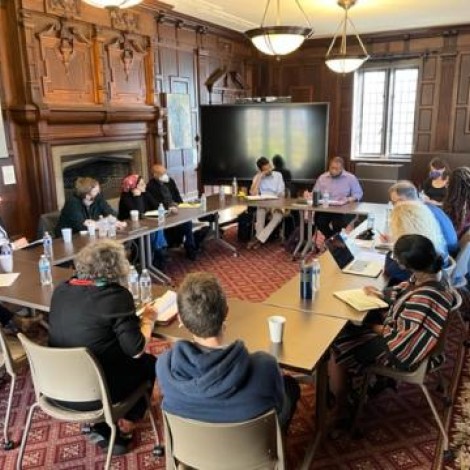 A group meeting around a conference table on the UChicago campus